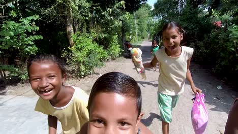 Poor-little-homeless-boys-and-girl-running-towards-camera-and-laughing,-enjoying-childhood,-poverty-and-innocence,-slow-motion-shot