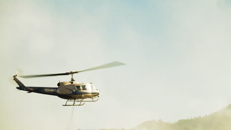 Helicopter-bucket-for-aerial-firefighting,-helicopter-landing-for-refuelling
