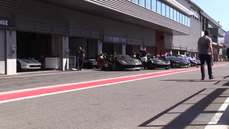 Two-safety-cars-remove-a-wrecked-vehicle-at-Circuit-De-Spa-Francorchamps,-Belgium