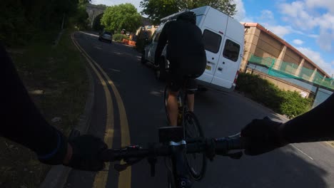 POV-Following-Cyclist-Riding-Turning-Towards-Dalton-Way-A411-Under-Railway-Bridge,-Watford