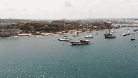 Fly-over-of-harbour-from-the-TignÃ©-Seafront-in-Sliema-city-in-Malta---Reveal-aerial-shot