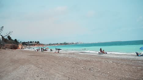 Tourists-Enjoying-Summer-At-The-Beach---Playa-Mar-Chica-In-Benicarlo,-Castellon,-Spain---wide-shot,-time-lapse