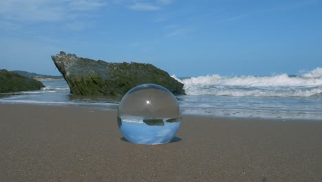 A-crystal-ball-on-the-sandy-beach-of-Wicklow,-Ireland---close-up