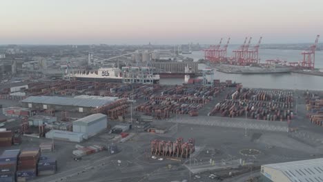 Aerial-view-above-harbour-freight-cargo-loading-shipyard-slow-left-dolly
