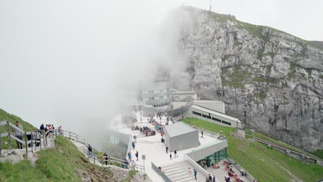 People-walk-at-Mt.-Pilatus-Kulm-summit,-handheld