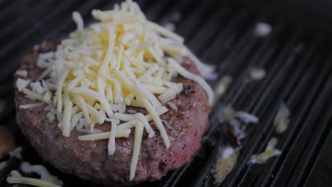One-hamburger-patty-frying-on-medium-heat-in-a-cast-iron-grill-skillet