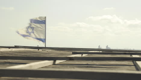 Zerrissene-Und-Zerfetzte-Flagge-Israels-Weht-Im-Wind-Auf-Dem-Dach-Mit-Blick-Auf
