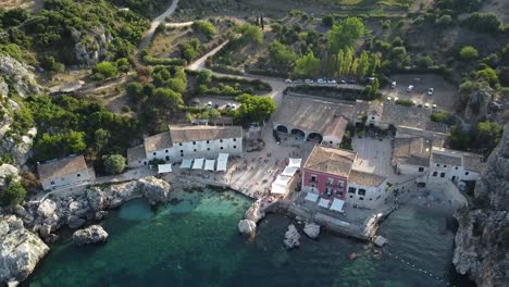 Aerial-top-down-showing-old-historic-italian-Scopello-town-in-Sicily-with-beautiful-rural-landscape-during-sunset