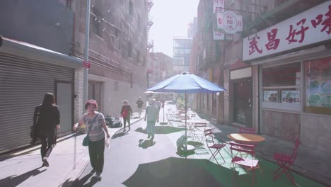 NYC:-Chinatown-on-a-bright-day-with-the-sun-beating-down-and-pedestrians-walking-past-local-businesses---New-York-City,-USA