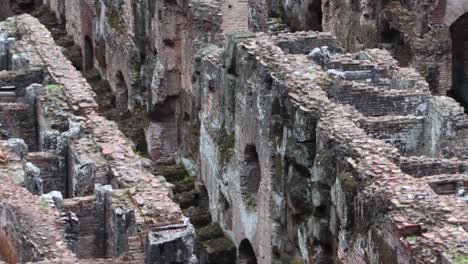 Close-up-of-the-rooms-under-the-arena-of-the-Colosseum,-Rome,-Italy