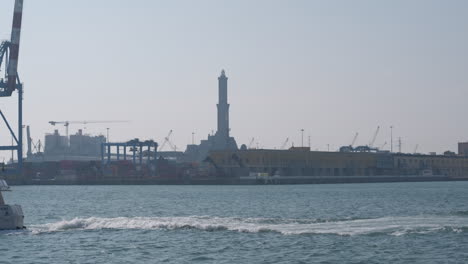 Genoa-Lanterna-lighthouse-in-port-harbor-and-boats-ships-sea-transportation