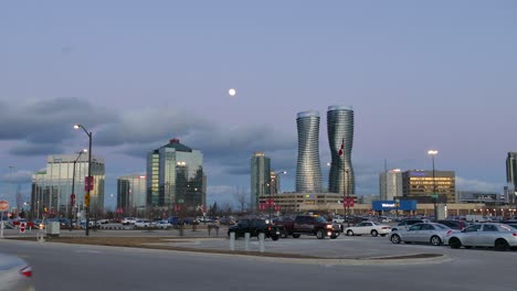 Mississauga-skyline-seen-from-parking-lot-as-car-drives-in-to-frame