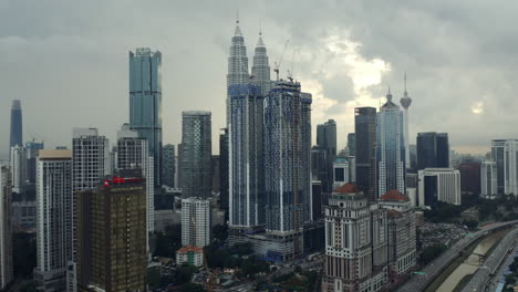 Tracking-Aerial-Shot-Of-Petronas-Twin-Towers-And-Kuala-Lumpur-City-Skyline-In-Malaysia