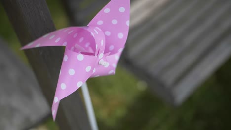 Pink-wind-mill-toy,-decorative-object-in-summer-celebration-event-in-the-garden