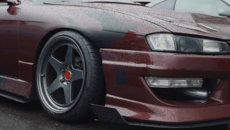 Nissan-240SX-Car-Body-and-Luxury-Alloy-Wheel-Rims-on-Rainy-Day-Slow-Motion-Close-Up