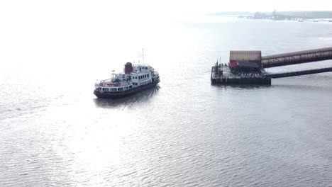 Vista-Aérea-Siguiendo-El-Ferry-De-Pasajeros-De-Mersey-En-El-Río-Brillante-Llegando-A-La-Estación-Woodside-Birkenhead