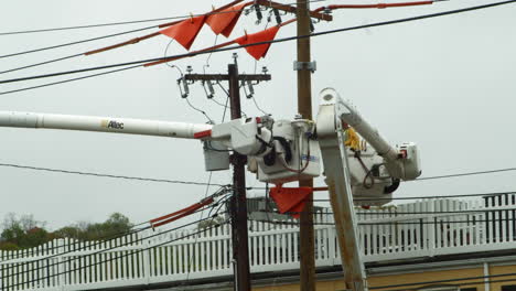 Close-up-shot-of-engineer-working-on-power-lines-on-a-cherry-picker,-California