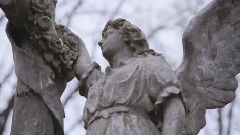 Old-Stone-Marble-Statue-of-Angel-with-Wings-on-a-Cloudy-Day