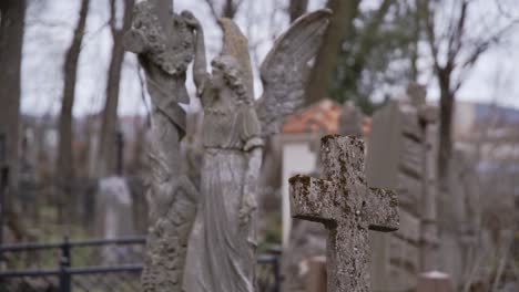 Rack-Focus-from-Old-Stone-Cross-to-Angel-Carved-from-Stone-in-a-Graveyard-in-Uzupis