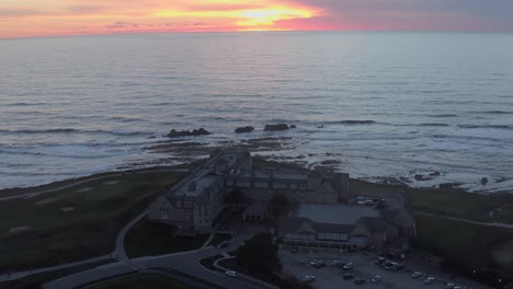 Aerial:-hotel-by-the-sea-at-sunset,-drone-view