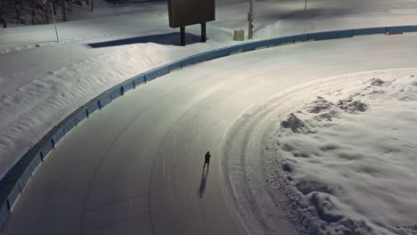 Solitary-skates-on-ice-rink-at-night,-Zakopane-in-Poland