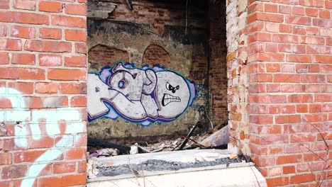 Graffiti-wall-art-in-old-paper-mill-ruins-in-Vargön,-Sweden,-wide-forward-shot