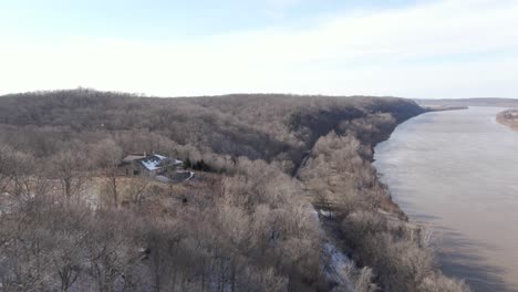Aerial-Drone-Footage-of-an-Abandoned-Lodge-Overlooking-a-River