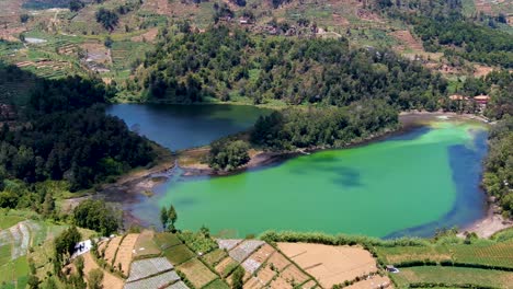 Cloud-shadow-move-on-Lake-Warna-in-Dieng-Plateau,-Central-Java-Indonesia,-aerial