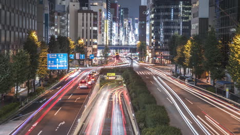 Timelapse-Of-Traffic-At-Night-With-Cityscape-Buildings-From-Yurikamome-Shimbashi-Station-Connecting-Passage-In-Higashishinbashi,-Minato-City,-Tokyo,-Japan