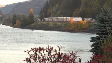 Highway-traffic-and-cargo-train,-interstate-freight-by-Columbia-River,-USA