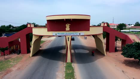 Traffic-gate-welcoming-visitors-to-Katsina-City-in-the-Katsina-State-of-Nigeria---pull-back-aerial-view
