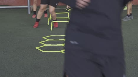 A-football-player-on-a-hexagonal-speed-and-agility-training-ladder-rings-in-the-field