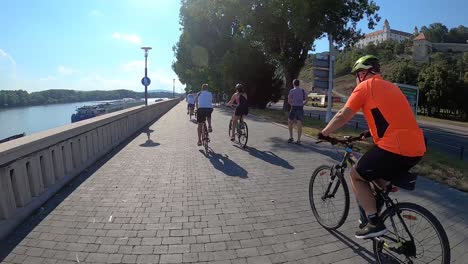 First-person-GoPro-point-of-view-people-cycling-in-Bratislava-on-sunny-day,-Slovakia