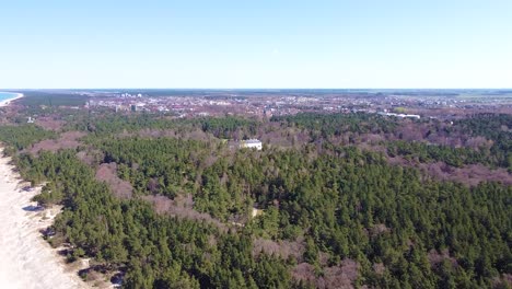 Amber-museum-and-Palanga-in-horizon-near-coastline-of-Baltic-sea,-aerial-view