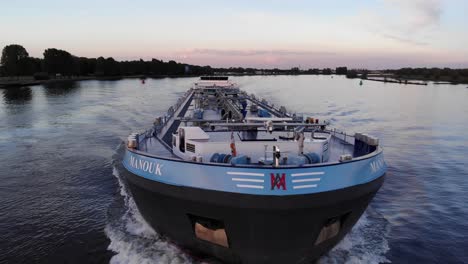 Front-View-Of-Liquid-Tank-Barge-Cruising-In-The-River-At-Sunset