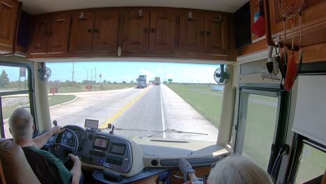 POV-of-man-driving-his-Tiffiin-Class-A-coach-on-interstate-overpass-in-southern-Missouri-and-does-jazz-hands