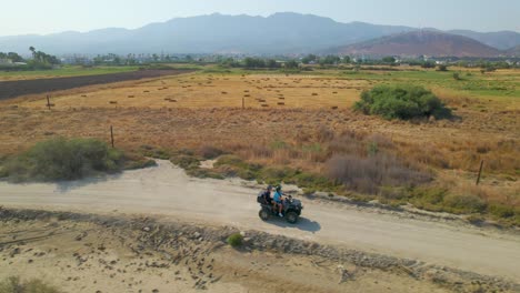 Side-aerial-view-of-ATV-driving-through-Greek-countryside