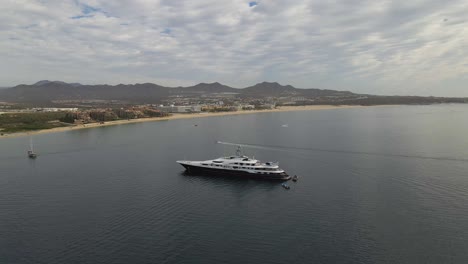 Aerial:-billionaire's-luxury-superyacht-moored-in-Pacific-Ocean,-Mexican-coast