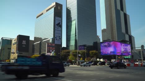 World-Trade-Center-Seoul---Cars-Traffic-Turning-at-Crossroads-Passing-Samseong-Station-near-Coex-Trade-Tower-and-Parnas-Tower-And-Grand-Intercontinental-Hotel-at-Sunset-in-Autumn,-Korea