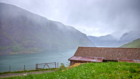misty-weather-over-countryside-in-norwegian-fiord,-Flam-village-area