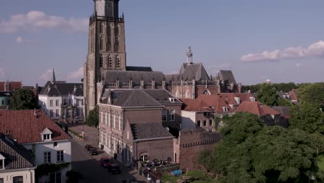 Ascending-aerial-view-of-Walburgiskerk-cathedral-in-Hanseatic-town-of-Zutphen-in-The-Netherlands-showing-its-surrounding-architecture-of-the-historic-square