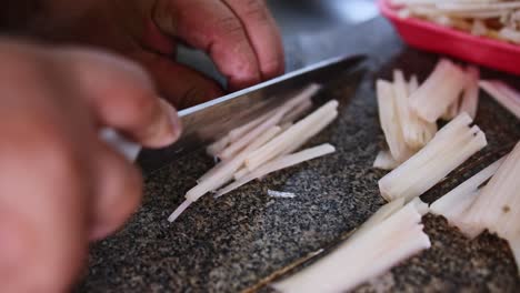 Slicing-palm-hearts-into-strips-for-recipe---harvested-from-sustainable-farms-in-the-Amazon-rainforest