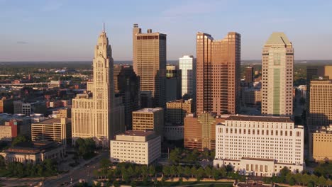 Aerial-drone-view-approaching-high-rise-in-Columbus,-sunny-evening-in-Ohio,-USA