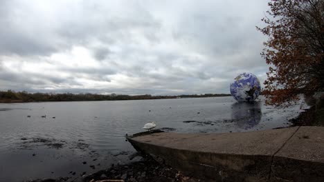 Luke-Jarram-floating-planet-earth-overcast-timelapse-at-Pennington-flash-lake