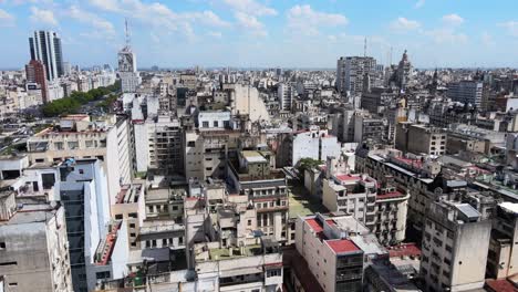 Panoramic-aerial-pan-shot-capturing-dense-urban-cityscape-with-a-mix-of-modern-and-old-architectures-and-high-rise-and-low-rise-buildings-in-downtown-Buenos-Aires,-Argentina