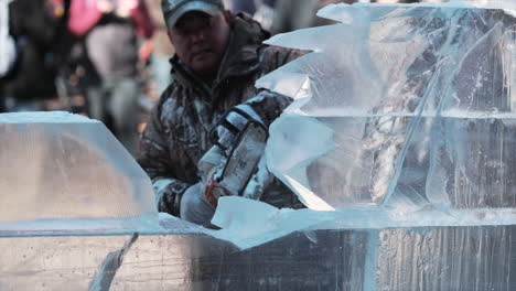 Slow-motion-clip-of-artist-carving-ice-sculpture-with-chainsaw