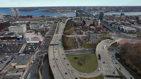 Philadelphia-USA,-Aerial-View-of-Interstate-Highway-Traffic,-Downtown-Buildings-and-Benjamin-Franklin-Bridge-Above-Delaware-River,-Drone-Shot