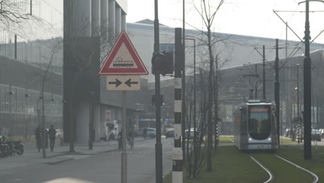Warning-sign-flashing-while-a-electric-trolley-drives-over-rail