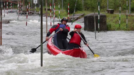 Close-up-slow-motion-shot-of-whitewater-kayakers-on-a-training-course