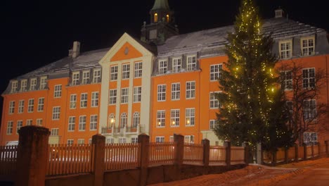 Facade-Exterior-Of-Kongsbakken-Upper-Secondary-School-With-Lighted-Christmas-Pine-Tree-In-Tromso,-Norway